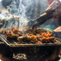 smoke-rising-from-a-grill-with-barbeque-skewers-cooking-over-hot-coals